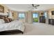 Relaxing main bedroom with a large window view and elegant, dark wood furnishings at 7343 Upton Ct, Castle Rock, CO 80104