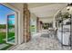 Covered patio with stone columns, tiled floor, and outdoor seating area at 7343 Upton Ct, Castle Rock, CO 80104
