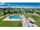 Aerial view of a backyard pool with a patio area and comfortable seating in a well-landscaped yard at 7343 Upton Ct, Castle Rock, CO 80104