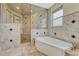 Modern bathroom showcasing a luxurious shower, soaking tub, and detailed tile work at 7343 Upton Ct, Castle Rock, CO 80104