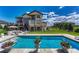 Inviting backyard pool area with comfortable lounge furniture, patio, and lush landscaping at 7343 Upton Ct, Castle Rock, CO 80104