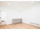 Spacious basement area with light wood floors and a stylish wet bar with gray cabinetry at 263 S Jackson St, Denver, CO 80209