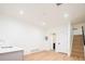 Large basement area with light wood floors, wet bar, and doorway to another room at 263 S Jackson St, Denver, CO 80209