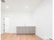Bright and open basement with light wood floors and a modern wet bar area at 263 S Jackson St, Denver, CO 80209