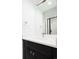 Bathroom featuring a modern dark vanity with white countertop and large mirror at 263 S Jackson St, Denver, CO 80209