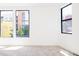 Bright bedroom featuring large windows and plush carpeting, offering views of the neighborhood at 263 S Jackson St, Denver, CO 80209