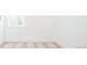 Bright bedroom with neutral carpet, white walls, and a window with blinds providing natural light at 263 S Jackson St, Denver, CO 80209