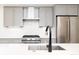 Close up view of the kitchen featuring stainless steel appliances, gray cabinets, and a quartz countertop at 263 S Jackson St, Denver, CO 80209