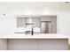 Modern kitchen featuring stainless steel appliances and a white countertop island at 263 S Jackson St, Denver, CO 80209