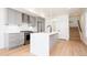 Bright modern kitchen with gray cabinets, stainless steel appliances, and a quartz countertop island at 263 S Jackson St, Denver, CO 80209