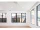 Bright living room featuring large windows and wood floors, providing an open and airy feel at 263 S Jackson St, Denver, CO 80209