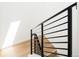 Modern staircase with sleek, horizontal black railing and light wood steps at 263 S Jackson St, Denver, CO 80209