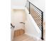 Modern staircase with a minimalist design and light wood steps and black metal railings at 263 S Jackson St, Denver, CO 80209