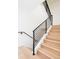 Modern staircase featuring light wood steps, black metal railings, and contemporary design at 263 S Jackson St, Denver, CO 80209