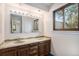Bathroom with granite counters, double sinks and wooden cabinetry at 15623 Degaulle Cir, Brighton, CO 80603