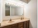 Bathroom featuring double sinks and vanity with an expansive mirror and ample lighting at 15623 Degaulle Cir, Brighton, CO 80603