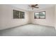 Bedroom featuring neutral walls, gray carpet and natural light from two windows at 15623 Degaulle Cir, Brighton, CO 80603