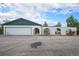 Exterior view of house showing a two car garage and arched privacy fence at 15623 Degaulle Cir, Brighton, CO 80603