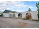 Exterior view of home showing garage and fence with arches, with landscaping at 15623 Degaulle Cir, Brighton, CO 80603