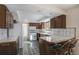 Updated kitchen boasts tiled floors, bar top, recessed lighting and plenty of counter space at 15623 Degaulle Cir, Brighton, CO 80603