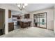 Open concept kitchen featuring tile floors and slider doors to the backyard at 15623 Degaulle Cir, Brighton, CO 80603