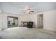Cozy living room with lit fireplace and sliding glass doors that lead to backyard at 15623 Degaulle Cir, Brighton, CO 80603