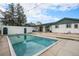 Backyard pool with privacy fence, mature trees, and string lights at 15623 Degaulle Cir, Brighton, CO 80603