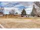 Open backyard space with mature trees at 8458 Everett Way # B, Arvada, CO 80005