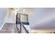 Modern staircase with metal railing leading to upper level at 8458 Everett Way # B, Arvada, CO 80005