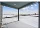 Covered back porch overlooking a snowy backyard at 25022 E 34Th Pl, Aurora, CO 80019