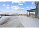 Snowy backyard with a view of neighboring houses at 25022 E 34Th Pl, Aurora, CO 80019