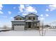 Two-story house with gray siding, stone accents, and a two-car garage at 25022 E 34Th Pl, Aurora, CO 80019