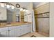 Bathroom boasts double sinks, decorative stone detail and a walk-in shower at 14882 E Maplewood Pl, Centennial, CO 80016