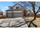 Charming two-story home with brick accents and three-car garage provides ample parking at 14882 E Maplewood Pl, Centennial, CO 80016