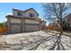 Charming two-story home with brick accents and three-car garage provides ample parking at 14882 E Maplewood Pl, Centennial, CO 80016