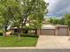 Brick house with 2-car garage, mature trees, and well-manicured lawn at 10933 Zephyr St, Broomfield, CO 80021