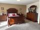 Main bedroom with large bed, dresser, and carpet flooring at 10933 Zephyr St, Broomfield, CO 80021