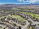 Picturesque aerial view of the neighborhood and golf course with the home prominently displayed at 7081 Salvia St, Arvada, CO 80007