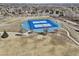 Aerial view of fenced tennis courts, surrounded by trees, in community at 7081 Salvia St, Arvada, CO 80007