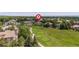 Beautiful aerial view overlooking a golf course and mature trees in a residential area at 7081 Salvia St, Arvada, CO 80007