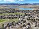 Expansive aerial view of the community and golf course with the home centrally located at 7081 Salvia St, Arvada, CO 80007