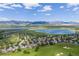 Picturesque aerial view of the community with scenic lakes and mountain views, providing a serene and natural backdrop at 7081 Salvia St, Arvada, CO 80007