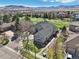 Stunning aerial view of a home and its surroundings, including a golf course and lush landscaping at 7081 Salvia St, Arvada, CO 80007