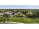 Stunning aerial view of home overlooking a golf course, surrounded by lush greenery at 7081 Salvia St, Arvada, CO 80007