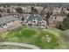 Aerial view of a house near a golf course, with a large backyard, deck, and patio for outdoor enjoyment at 7081 Salvia St, Arvada, CO 80007