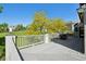 Back deck, with white railings, offers a scenic view, perfect for outdoor relaxation or entertaining guests at 7081 Salvia St, Arvada, CO 80007