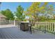 Back deck with a patio table and chairs provides a comfortable outdoor space to enjoy the beautiful landscape at 7081 Salvia St, Arvada, CO 80007