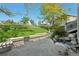 Backyard patio with a built-in stone wall, a mini-waterfall, and manicured landscaping creating a serene outdoor space at 7081 Salvia St, Arvada, CO 80007
