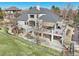 A home's sprawling backyard featuring a large deck and patio area, perfect for outdoor entertaining at 7081 Salvia St, Arvada, CO 80007