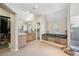 Bathroom featuring a sunken tub, separate shower, and closet at 7081 Salvia St, Arvada, CO 80007